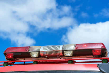 Vehicle light bar on fire truck with a blue sky in the background.